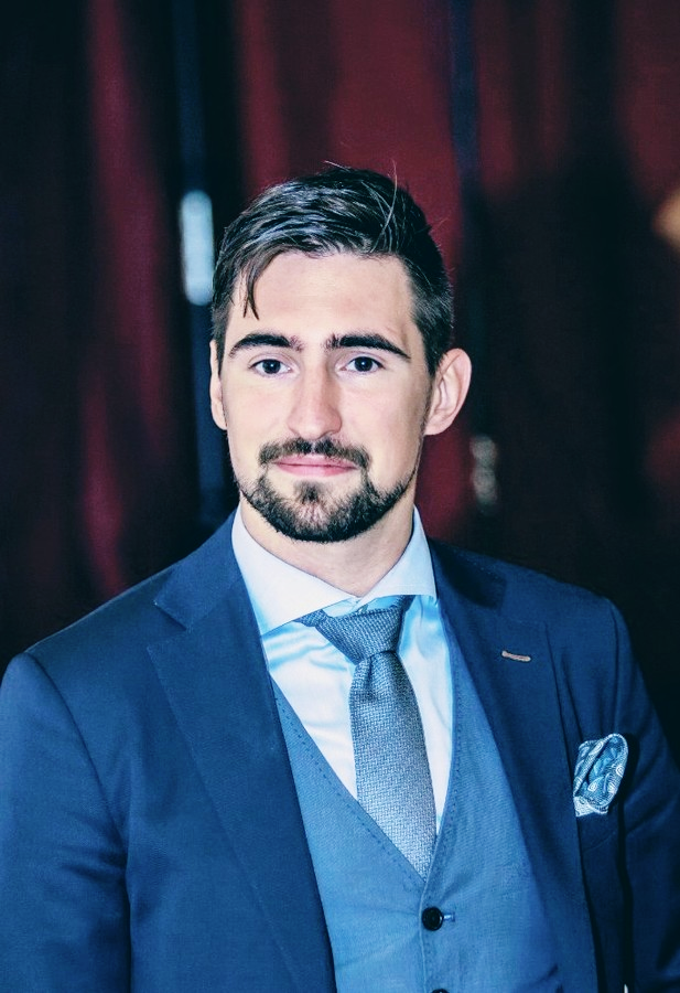 A image of a concrete sphere, balanced between two other larger spheres